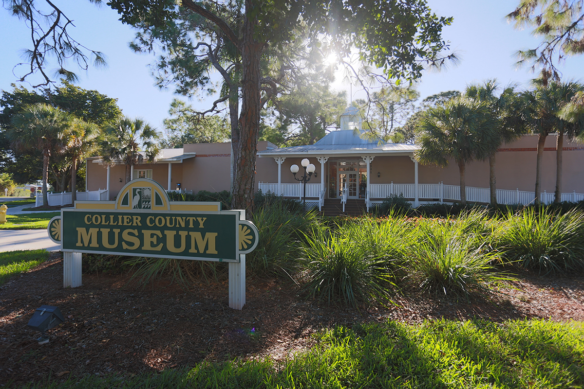 backlit single story building with a sign that says Collier County Museum