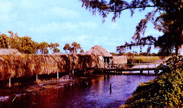 A Seminole village with a river running in front