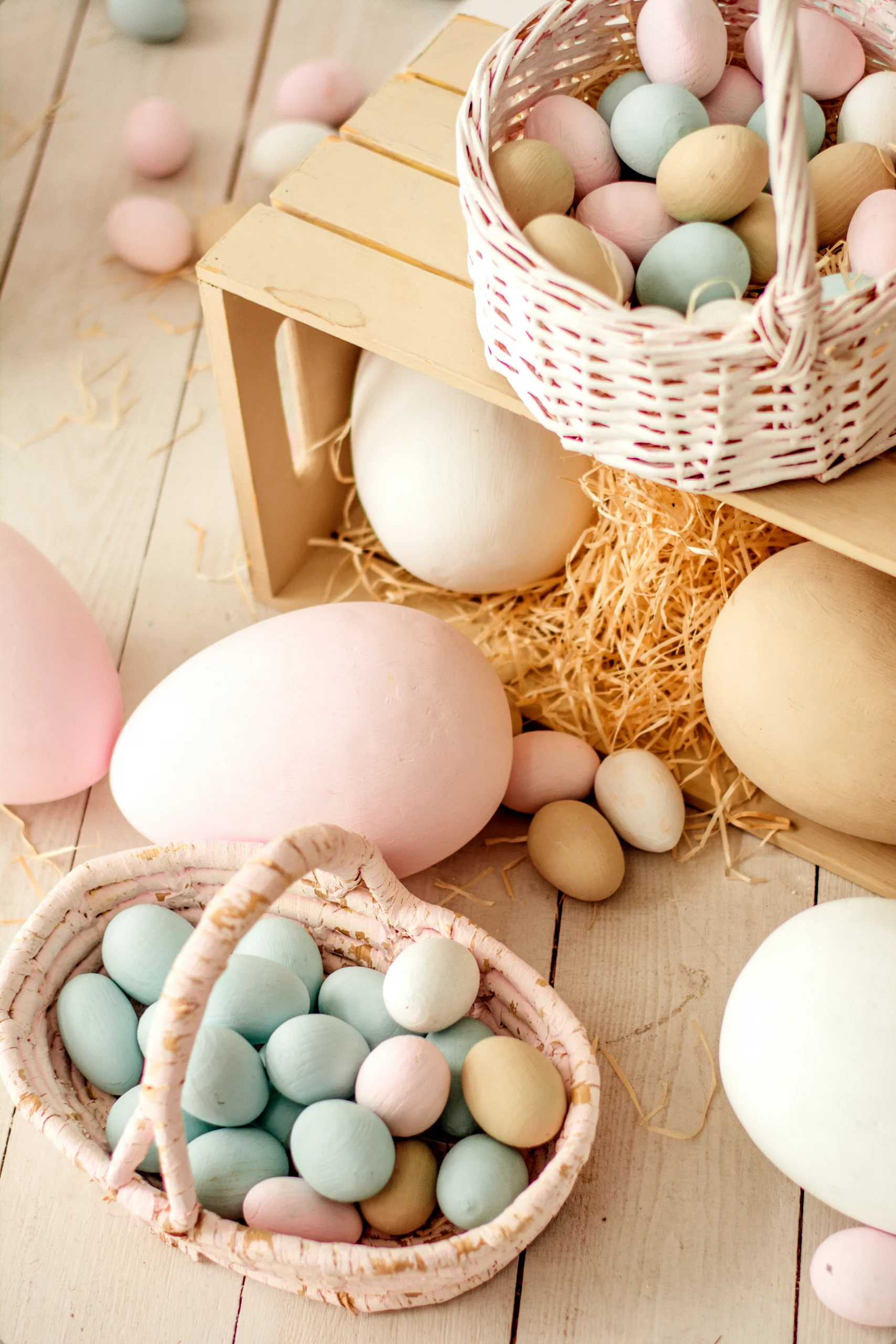 Display of colorful eggs in pale pink baskets