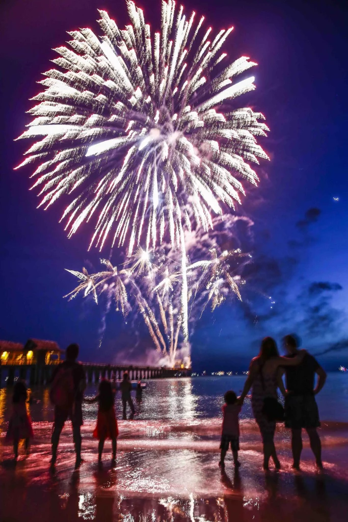 Fireworks over a beach at night